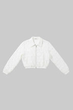 White lace cropped jacket with a front zipper and pointed collar, laid flat on a gray wood-look floor.