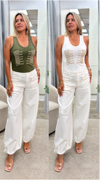 A side-by-side comparison of a woman modeling a sleeveless tank top with gold lace-up details. On the left, the top is olive green, and on the right, it is white.